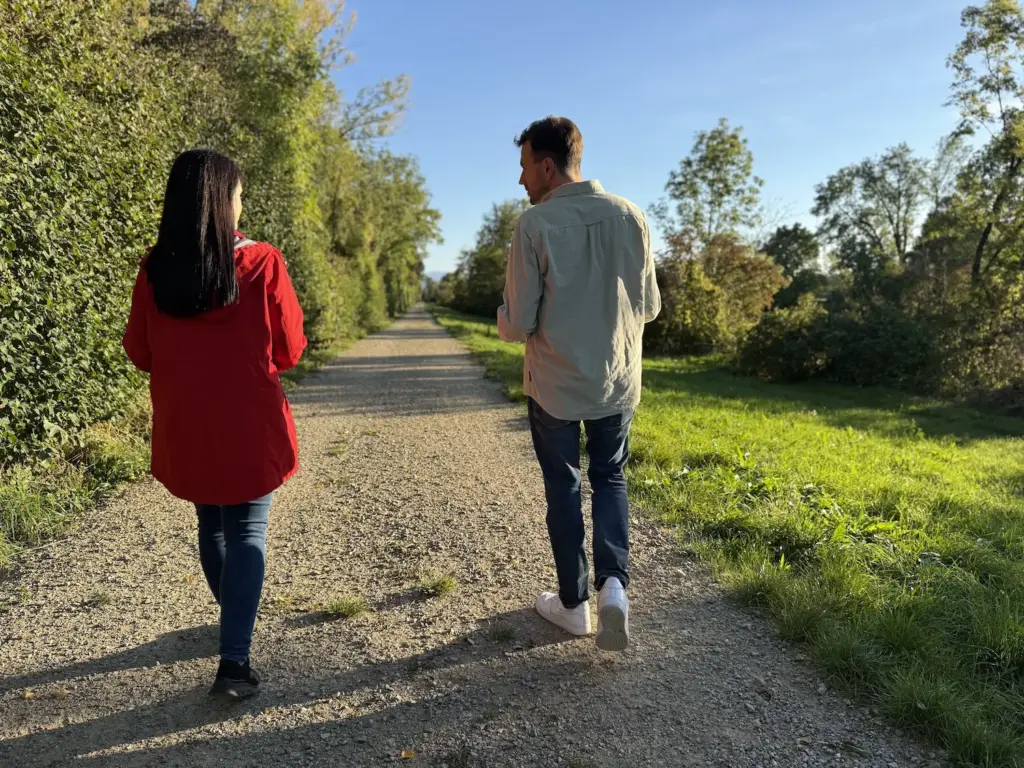 Rainhard Jandl spaziert mit einer Person und führt ein Beratungsgespräch im Freien (Walk & Talk)